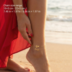 Double layer ankle bracelet featuring an Infinity symbol and a letter B charm on a woman's ankle