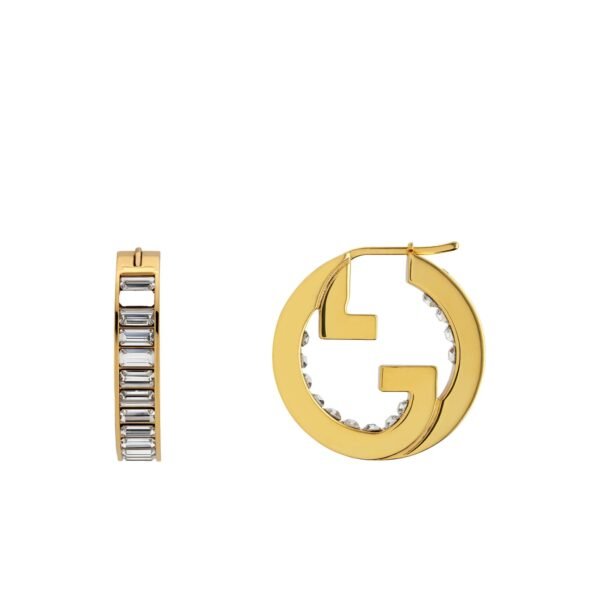 Close-up of Gucci Blondie light gold-toned hoop earrings with crystal embellishments.