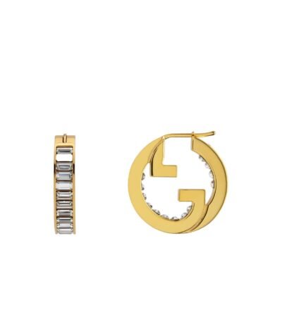 Close-up of Gucci Blondie light gold-toned hoop earrings with crystal embellishments.