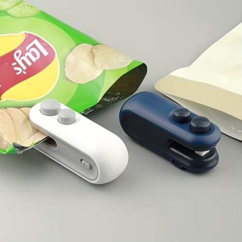 Handheld white mini bag sealer with USB-C port sealing a plastic potato chip bag.