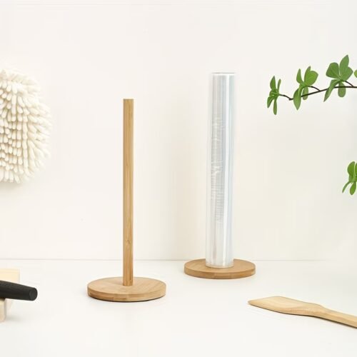 A standing light-colored wooden paper towel holder standing on a kitchen counter.