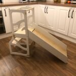 Convertible 3-in-1 kids learning tower shown in stool, desk, and slide positions made of natural birch plywood.