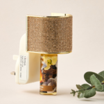 Gold crystal-embellished electrical wall plug-in with an Oud fragrance refill.