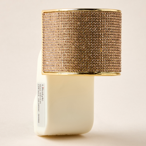 Gold crystal-embellished electrical wall plug-in with an Oud fragrance refill.