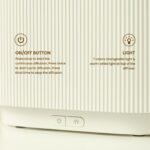 Black electric aroma diffuser with orange LED flame-effect mist.