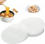 White round oil-absorbing paper mats placed under fried snacks on a plate.
