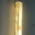 Lelantos waterproof LED wall light with iron finish and copper accents mounted on a modern wall.