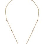 Close-up of Valentino Garavani Mini VLogo pendant with Swarovski crystals on a metal chain.