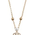 The Valentino Garavani VLogo Signature necklace featuring a pearl and Swarovski crystal pendant on a gold-tone chain.