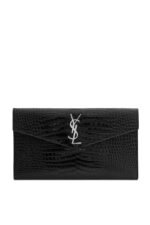 Front view of YSL Uptown Pouch in black crocodile-embossed leather with silver YSL initials