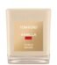 A Tom Ford vanilla-scented candle in a signature vanilla-hued glass jar with a cream label.