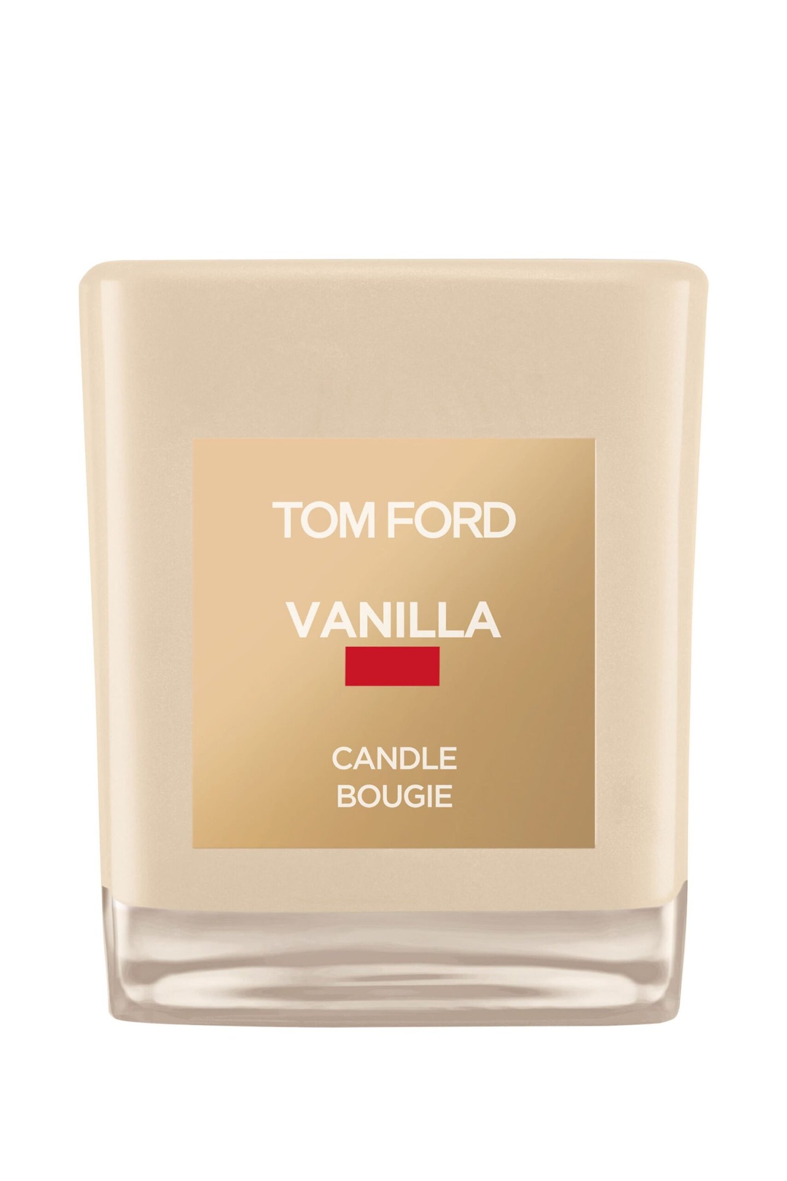 tom-ford-vanilla-scented-candle-vanilla-glass A Tom Ford vanilla-scented candle in a signature vanilla-hued glass jar with a cream label.