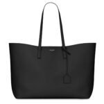 Saint Laurent East/West black leather tote bag with gold YSL charm and detachable pouch.