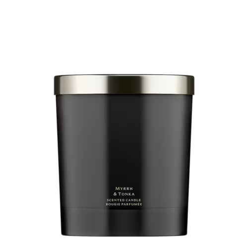 A minimalist black glass Jo Malone London Myrrh & Tonka Home Candle on a neutral background.