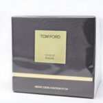 A Tom Ford vanilla-scented candle in a signature vanilla-hued glass jar with a cream label.