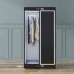 Freestanding smart clothing care wardrobe with digital touch interface.