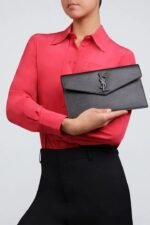 Front view of Saint Laurent Uptown Pouch in black Grain de Poudre leather with YSL logo