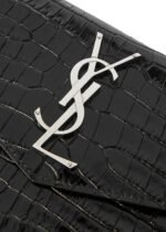 Front view of YSL Uptown Pouch in black crocodile-embossed leather with silver YSL initials