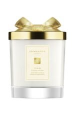 A Jo Malone London Pine & Eucalyptus Scented Candle in a decorative holiday glass jar with a silver lid.