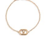 Valentino Garavani Ovalette gold-tone bracelet featuring a Swarovski pearl and VLogo emblem.