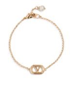 Valentino Garavani Ovalette gold-tone bracelet featuring a Swarovski pearl and VLogo emblem.